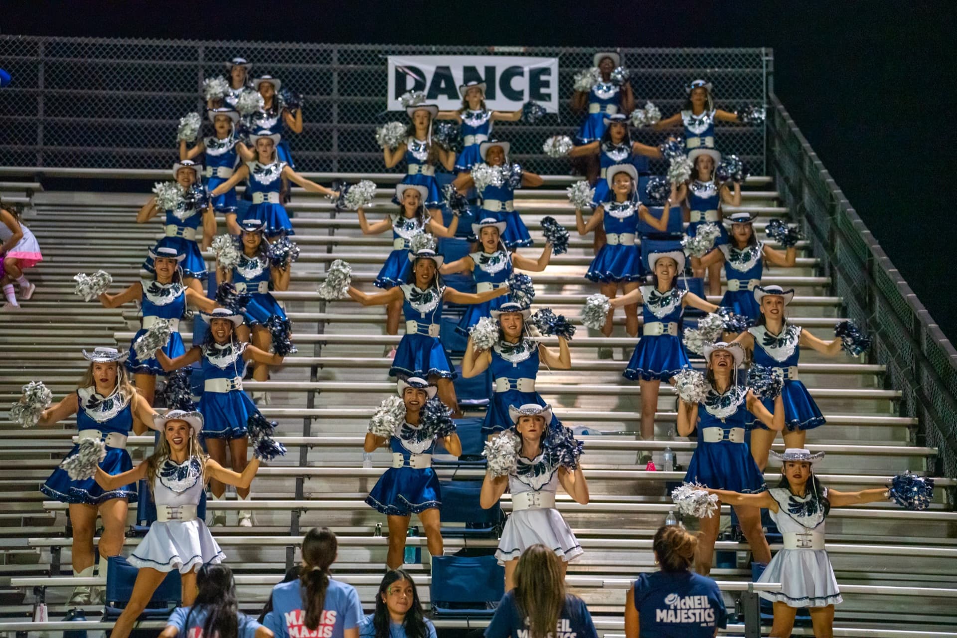 McNeil cheer team performing during a football game