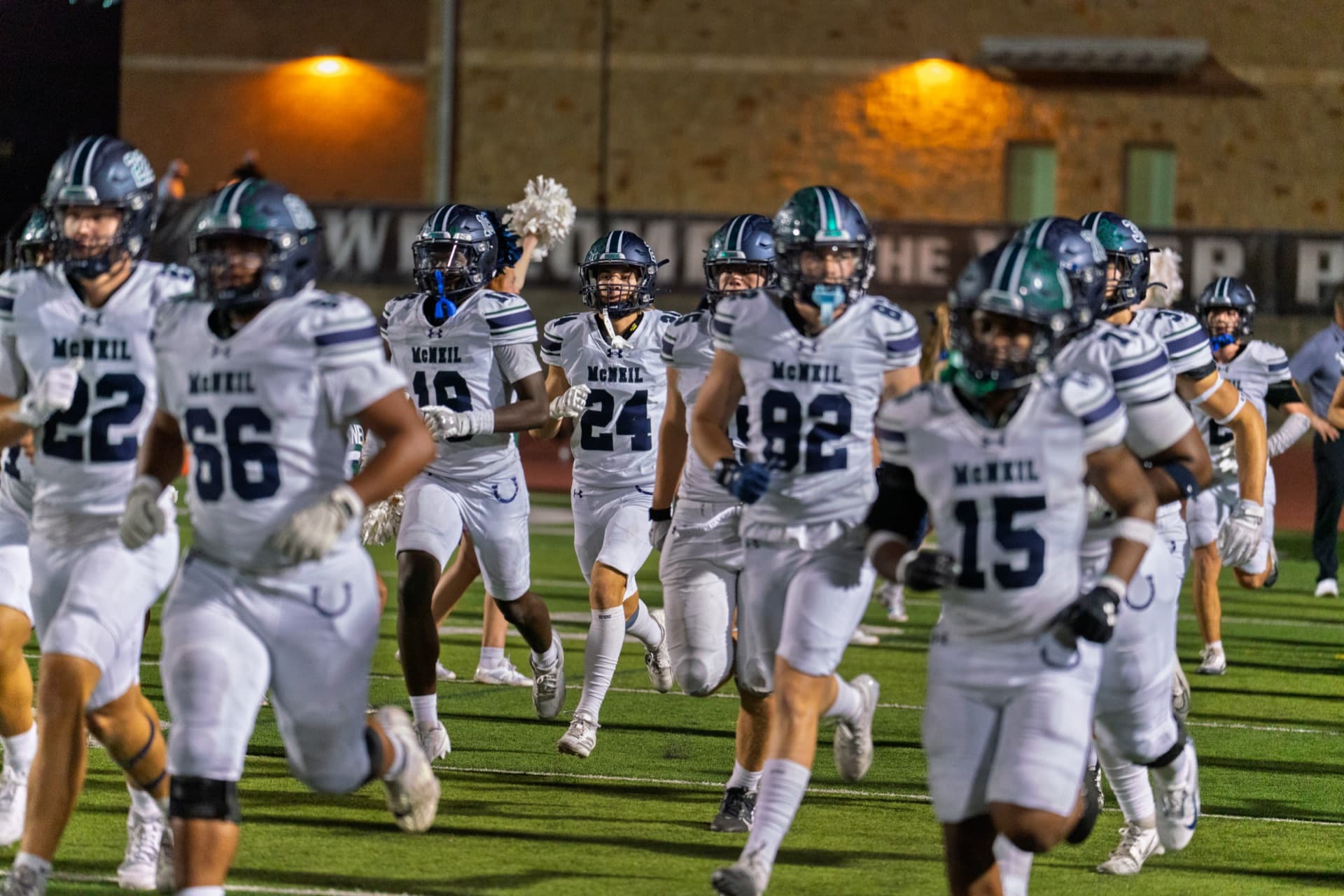 McNeil Mavericks football team running onto the field